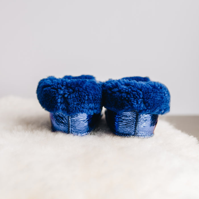 Back view of Westmorland Sheepskins Soft Soled Metallic Blue foil Baby Sheepskin Boots with a blue Sheepskin Cuff and laces.