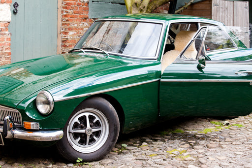 Vintage green car with a Sheepskin car seat cover inside.