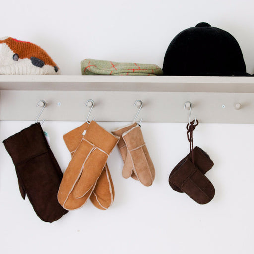 Various colours of Children's Mittens hung on coat hooks. Colours shown are Brown, Tan and Natural. Features both Children's and Baby/Toddler Mittens.