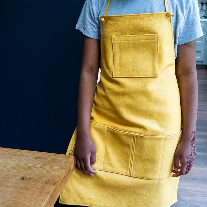 Yellow Leather Hobbyist Apron with multiple front pockets and tyable neck and back straps.