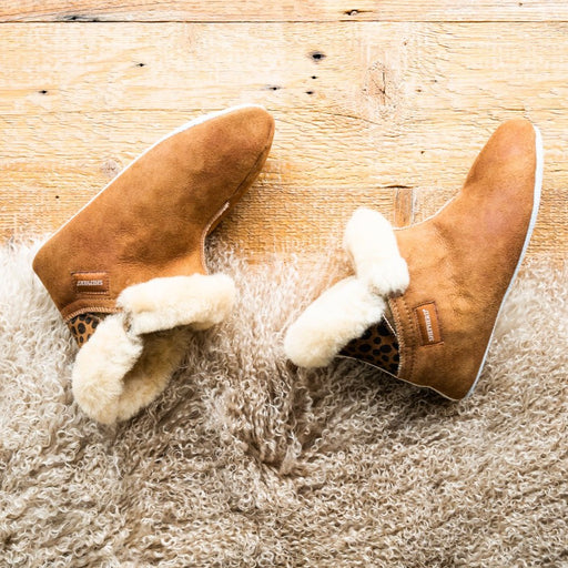 Mariette Soft Soled Sheepskin Boot Slipper from Shepherd of Sweden on a Sheepskin curly rug