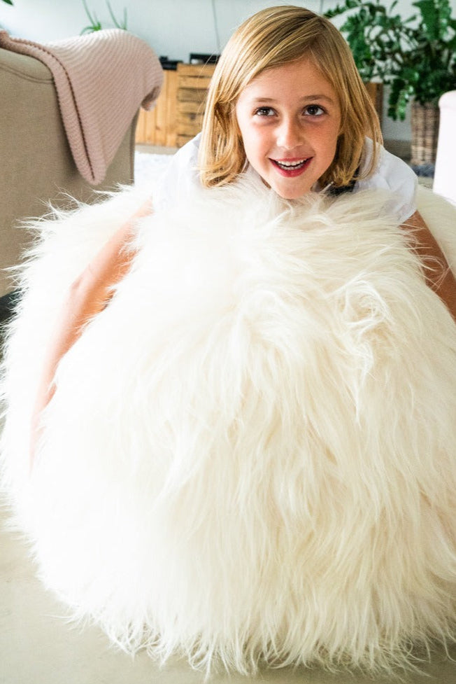 White Full Sheepskin Yoga / Exercise Ball. Child sat on top.