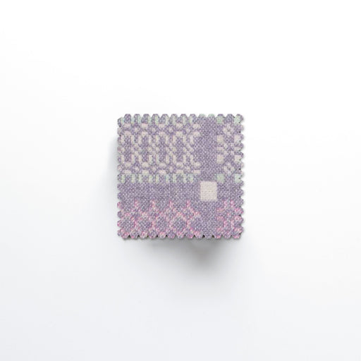 Melin Tregwynt Knot Garden Lilac Woven Wool Coasters with a crimped edge.