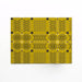 Melin Tregwynt Knot Garden Tablemats in Gorse Yellow. Gorse woven wool tablemats, features a repeating pattern in grey, whte and daffodil yellow.
