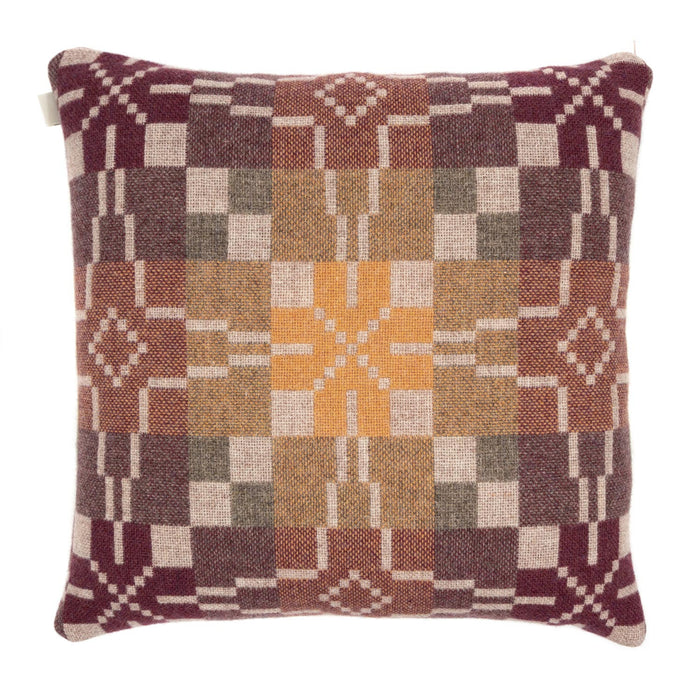 Reverse of Melin Tregwynt Vintage Star Woven Wool Cushion in Clay. A mixture of naturally warm colours including oatmeal, terracotta, yellow and maroon cushion with vintage star repeating pattern.